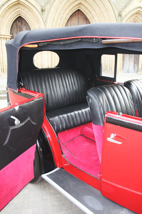 1933 Austin 16 Tourer with black leather interior, cherry red carpeting, fully convertible roof